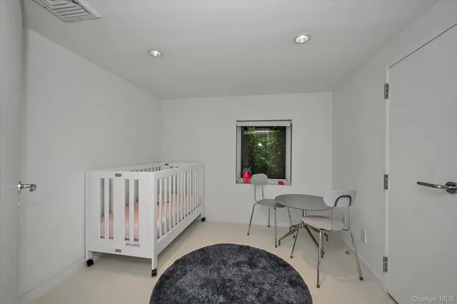 a living room with a bed furniture and a window