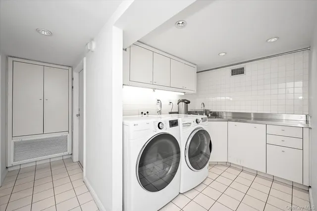 a utility room with sink dryer and washer