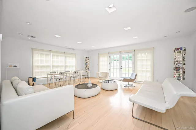 a living room with furniture and large windows