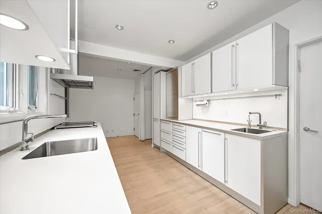 a kitchen with a sink and cabinets