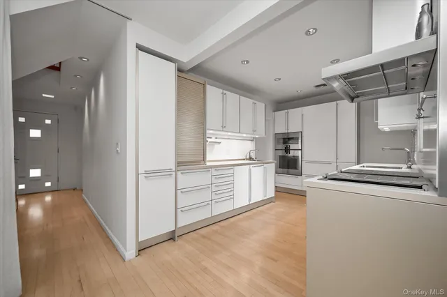 a kitchen with stainless steel appliances a refrigerator and a stove top oven