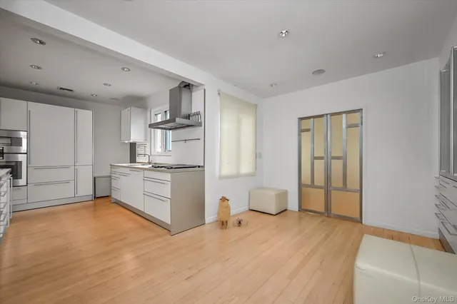 a kitchen with stainless steel appliances a refrigerator and a stove top oven