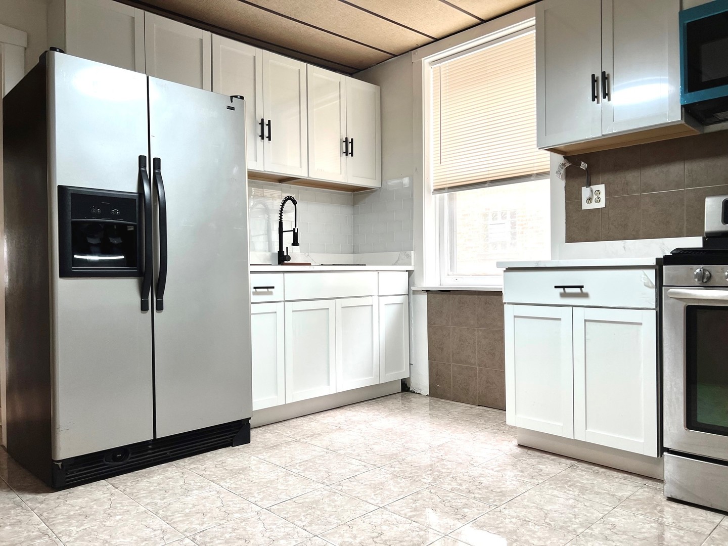 1940 Ridgeland Avenue Berwyn, IL 60402 - Photo 16 of 24 a kitchen with white cabinets and white appliances