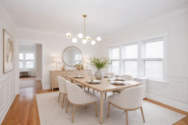 a view of a dining room with furniture window and wooden floor