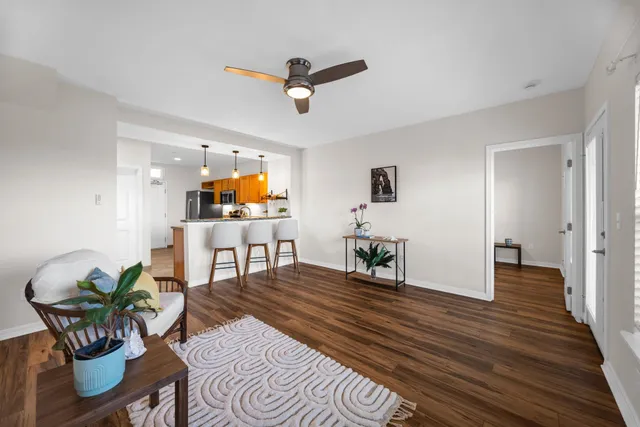 a living room with furniture and a wooden floor