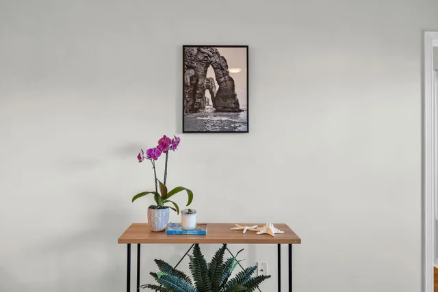 a kitchen with stainless steel appliances granite countertop a sink and a chairs