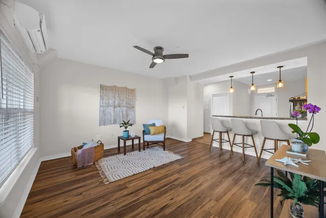 a living room with furniture and wooden floor