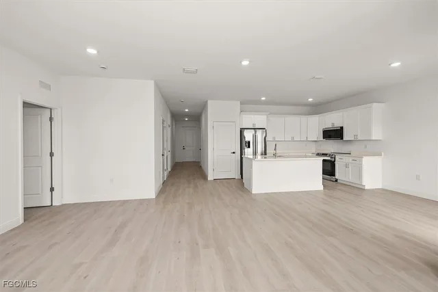 a view of a kitchen with a sink and a refrigerator