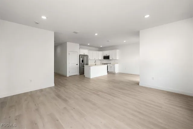 a view of a kitchen with a sink and a refrigerator