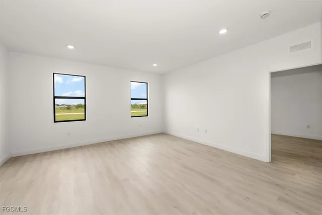 an empty room with windows and entrance