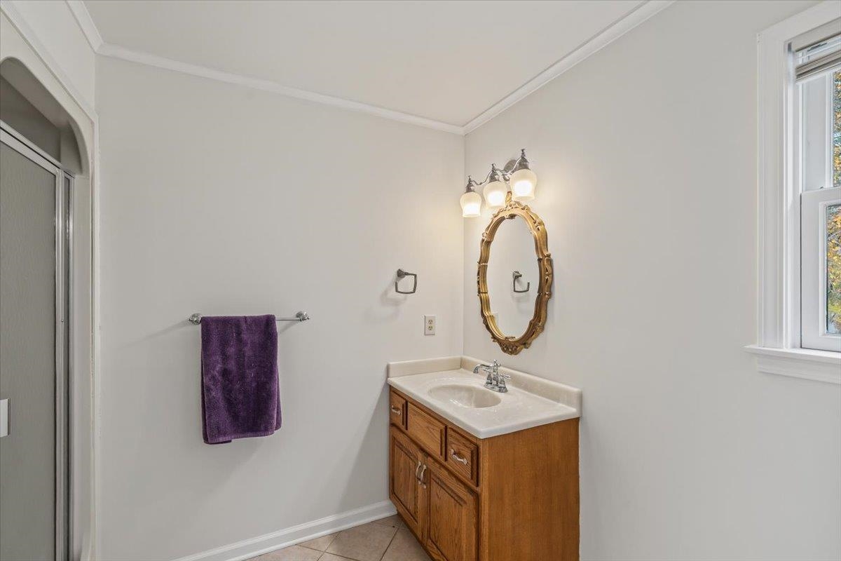 102 Linden Street Grand Junction, TN 38039 - Photo 19 of 37 Full bath with vanity, ornamental molding, light tile patterned floors, and a stall shower