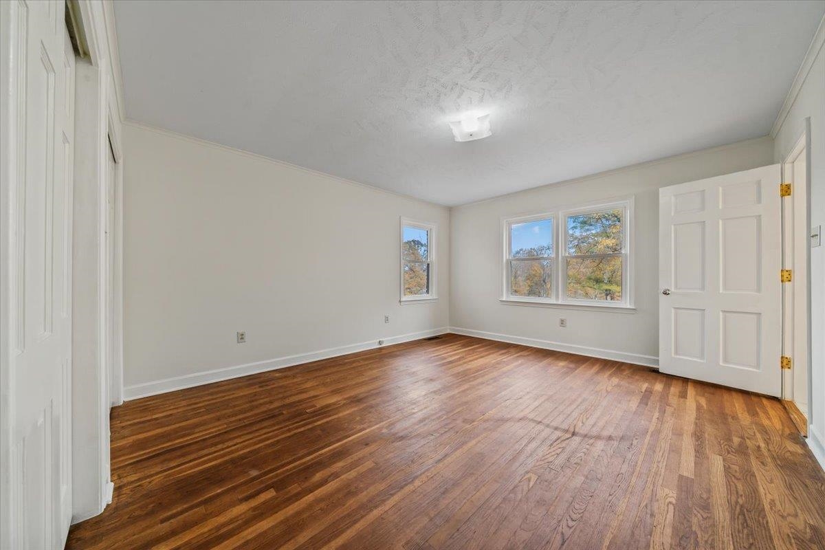 102 Linden Street Grand Junction, TN 38039 - Photo 20 of 37 Unfurnished bedroom with dark wood-style floors and a textured ceiling