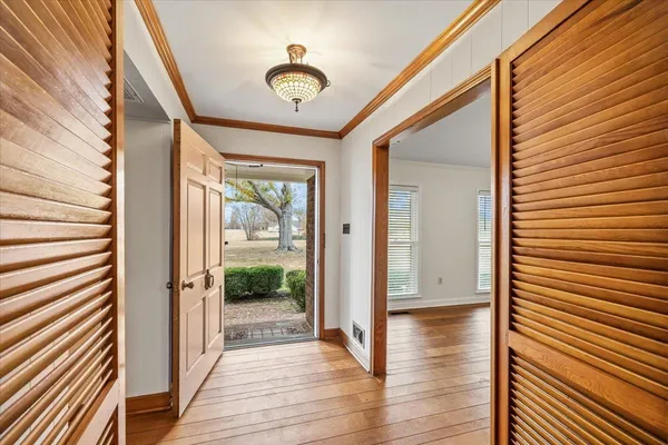 a view of a livingroom with wooden floor and stairs