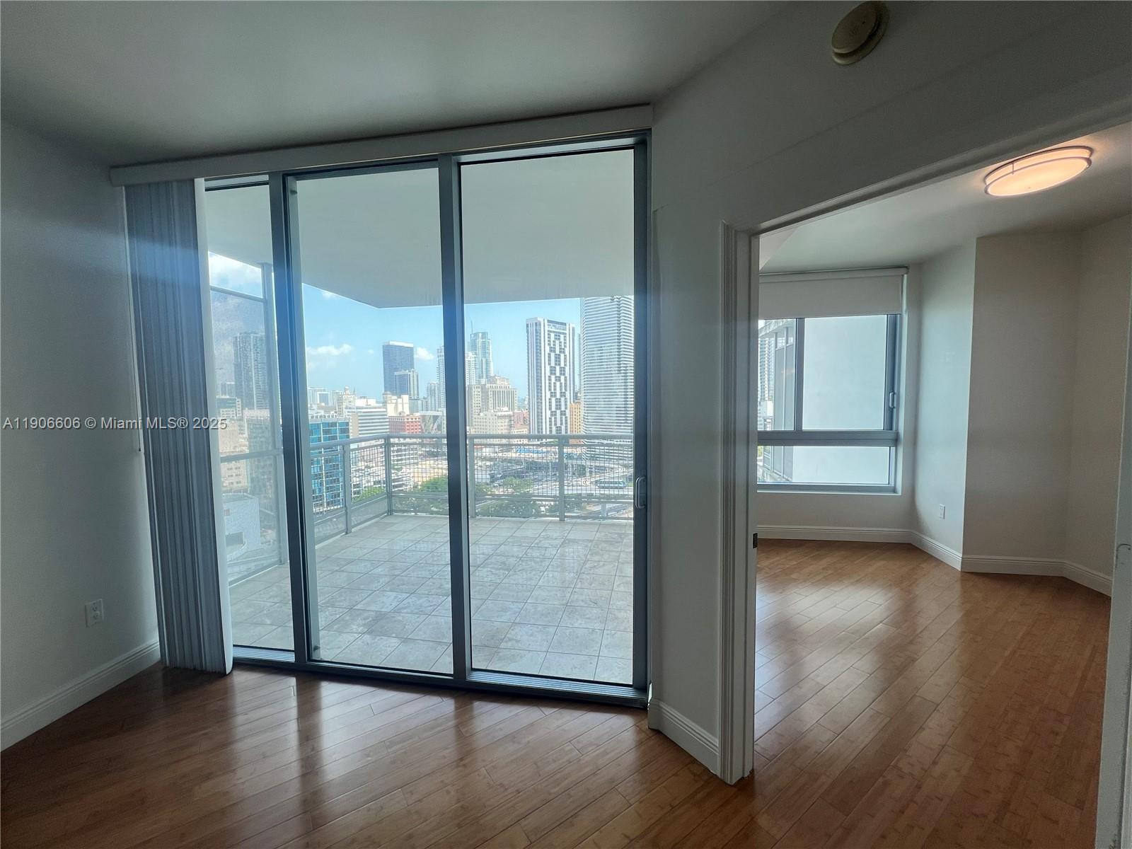 350 South Miami Avenue, Unit 1905 Miami, FL 33130 - Photo 14 of 27 a view of a glass door and wooden floor