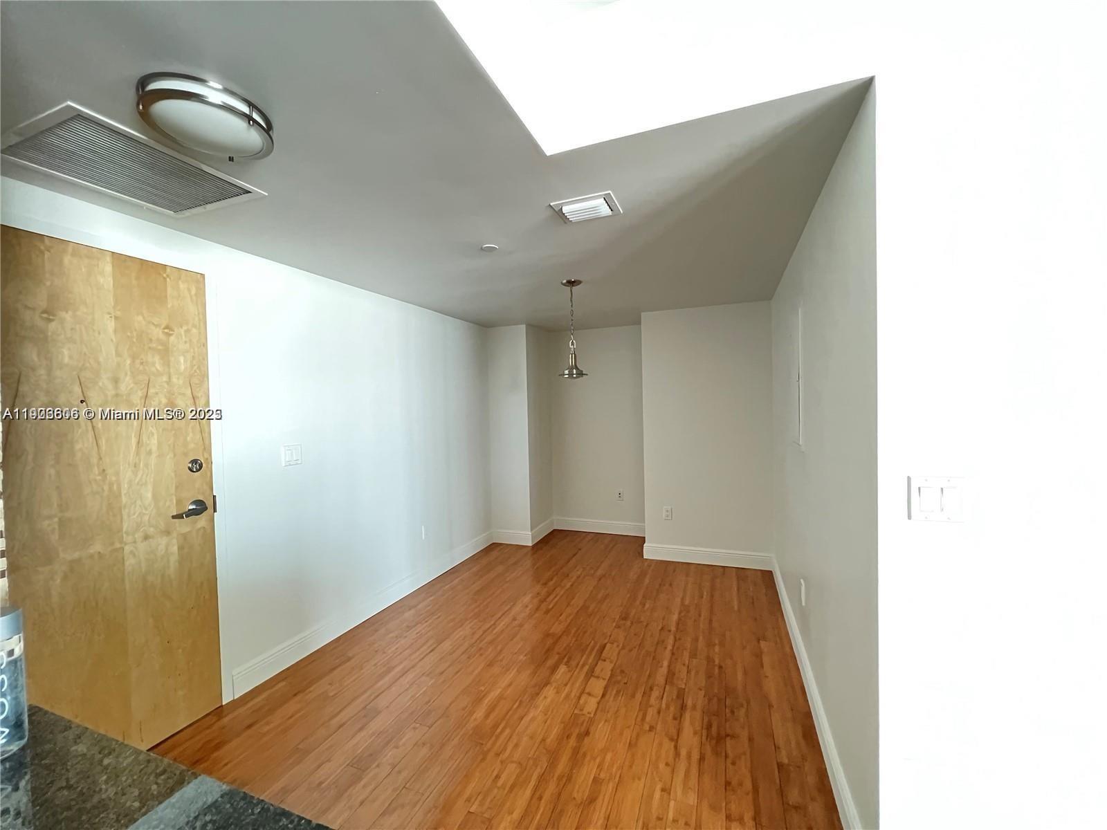 350 South Miami Avenue, Unit 1905 Miami, FL 33130 - Photo 4 of 27 a view of a room with wooden floor and a ceiling fan