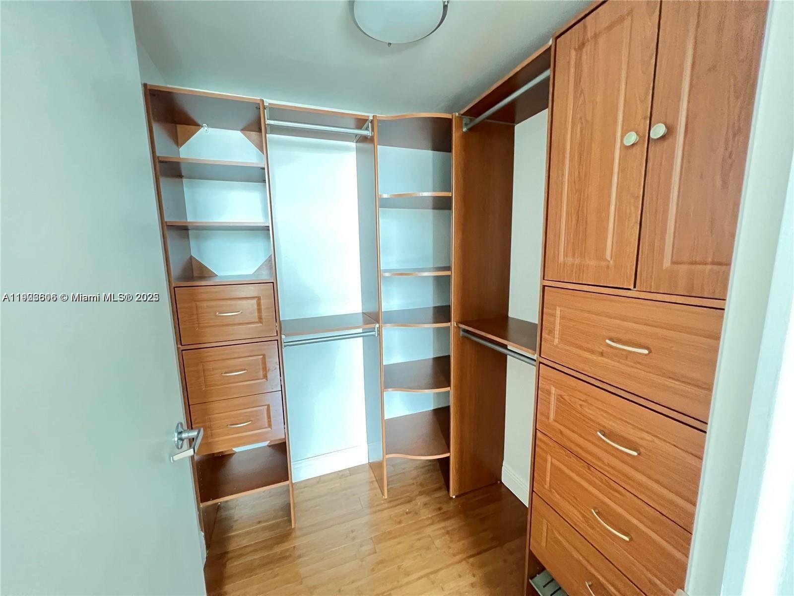 350 South Miami Avenue, Unit 1905 Miami, FL 33130 - Photo 8 of 27 a room with walk in closet and wooden floor