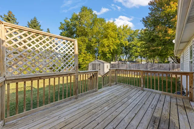 a view of balcony with wooden floor and fence