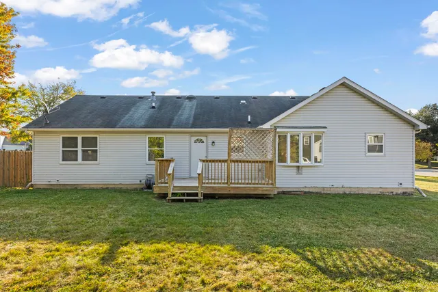 a front view of a house with a garden and yard