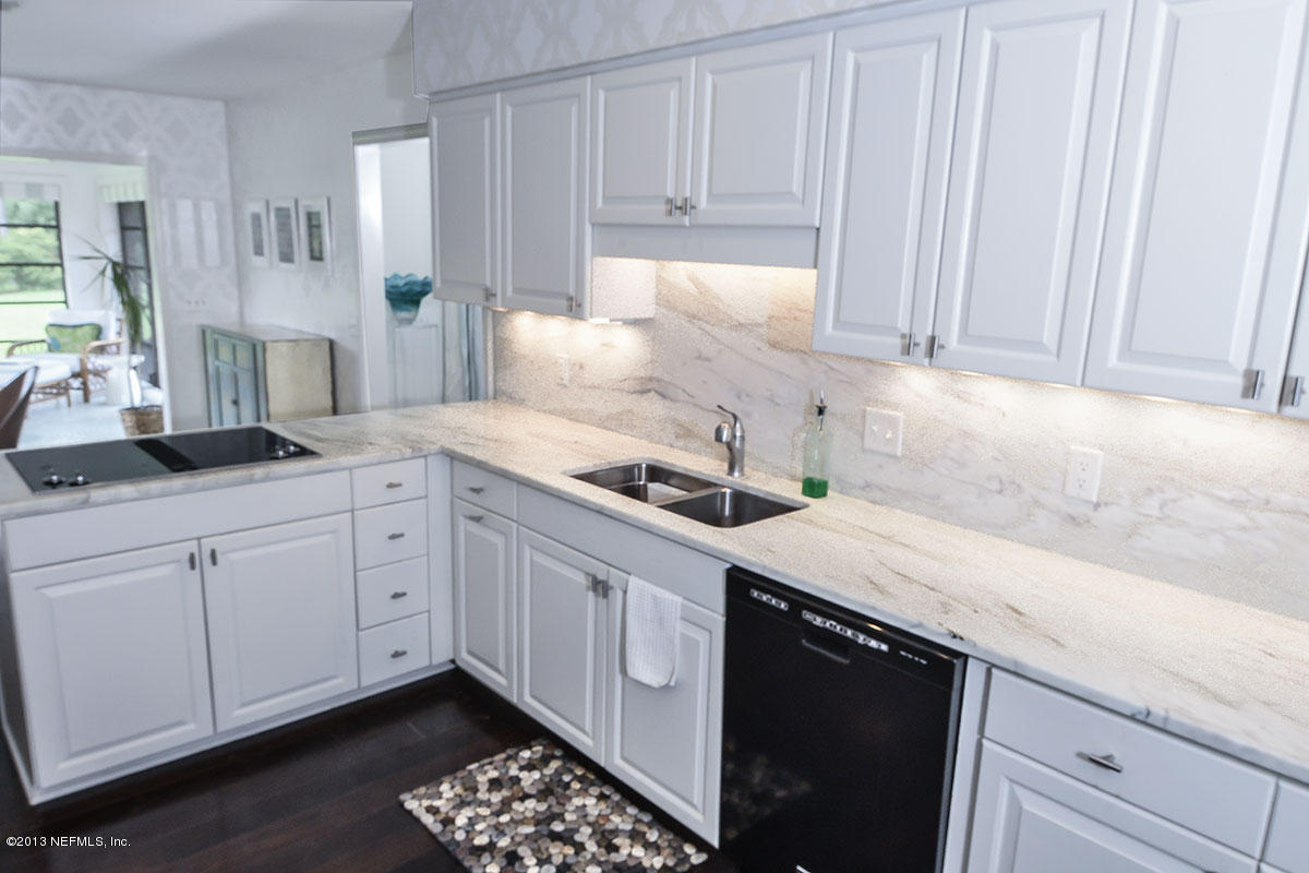 302 Pablo Road Ponte Vedra Beach, FL 32082 - Photo 11 of 28 a kitchen with a sink dishwasher and white cabinets