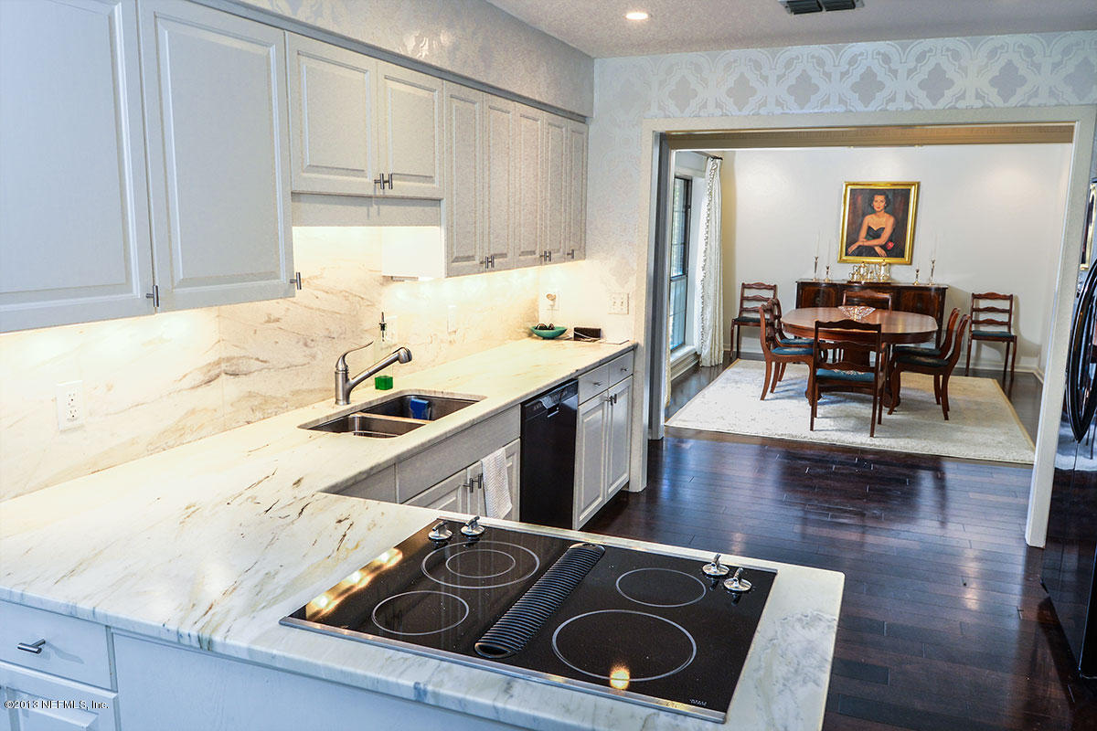 302 Pablo Road Ponte Vedra Beach, FL 32082 - Photo 12 of 28 a kitchen with a sink stove and wooden floor