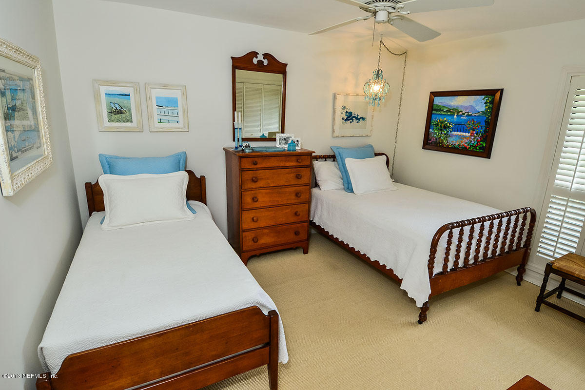 302 Pablo Road Ponte Vedra Beach, FL 32082 - Photo 16 of 28 a bedroom with a bed and a chandelier