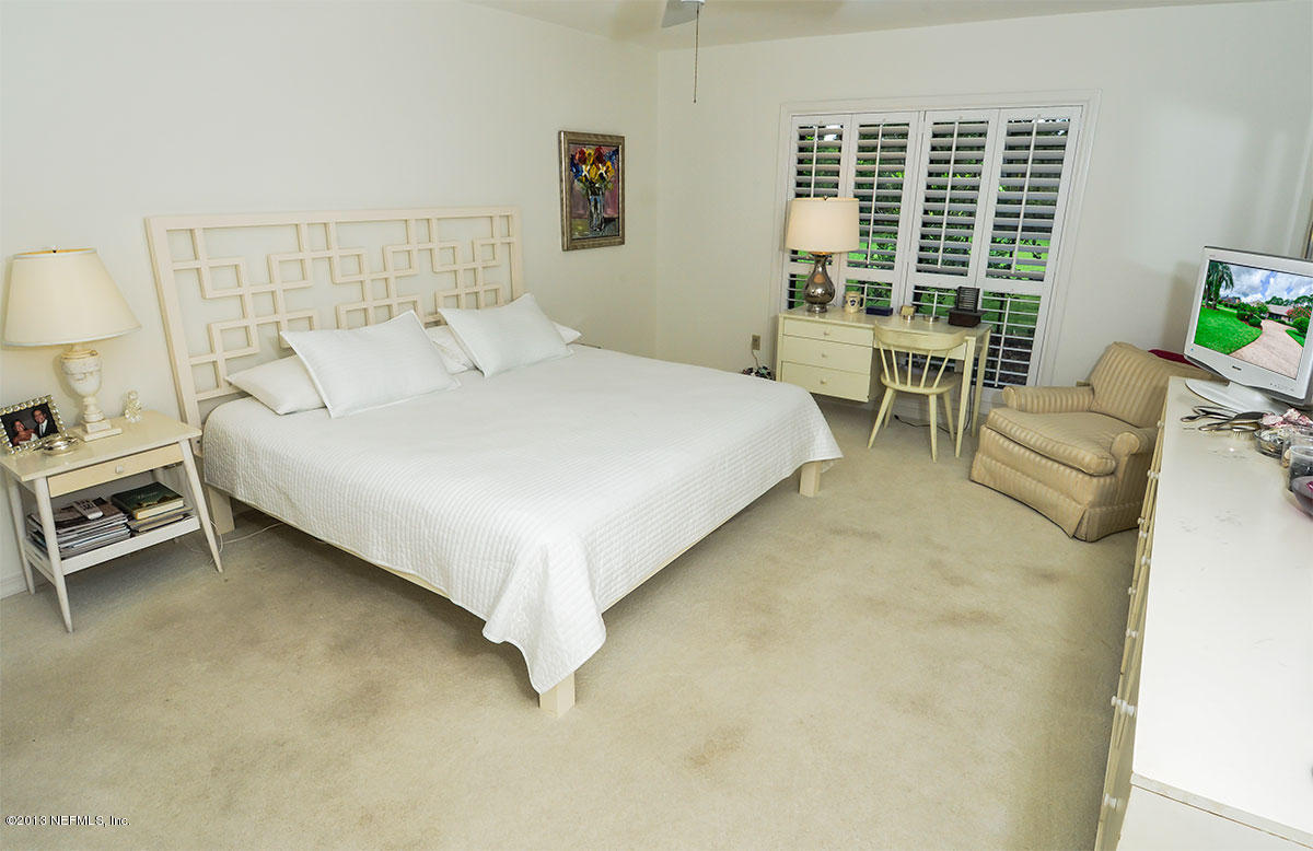 302 Pablo Road Ponte Vedra Beach, FL 32082 - Photo 21 of 28 a bedroom with a bed chair and a window