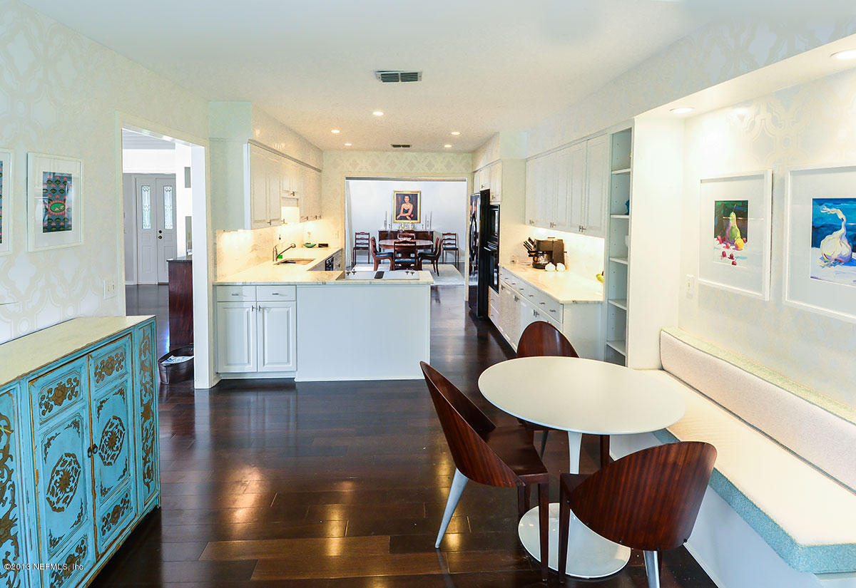 302 Pablo Road Ponte Vedra Beach, FL 32082 - Photo 10 of 28 a kitchen with stainless steel appliances granite countertop a dining table chairs refrigerator and sink