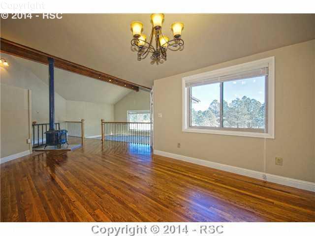 12150 Dawson Road Elbert, CO 80106 - Photo 7 of 25 Extensive HW Flooring in Kitchen and Adjoining Casual Dining Area
