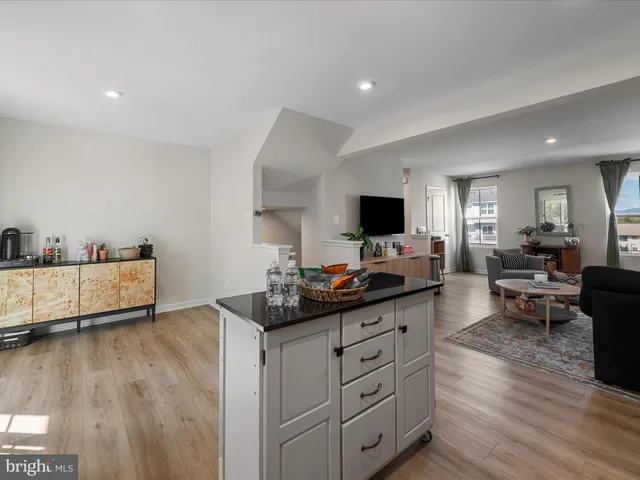 a kitchen with a sink cabinets and wooden floor