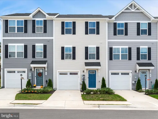 a front view of a residential houses with yard