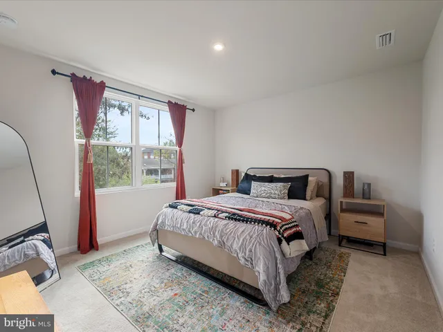 a bedroom with bed and a window