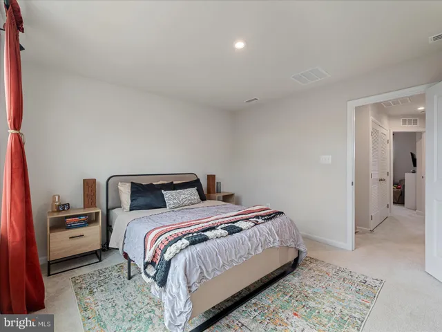 a bed room with a bed and a rug