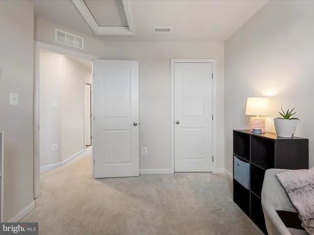 a view of bedroom with furniture and lamp