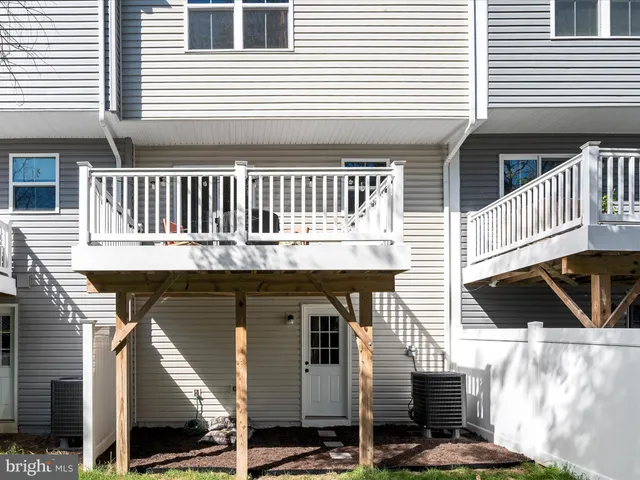 a balcony with table and chairs
