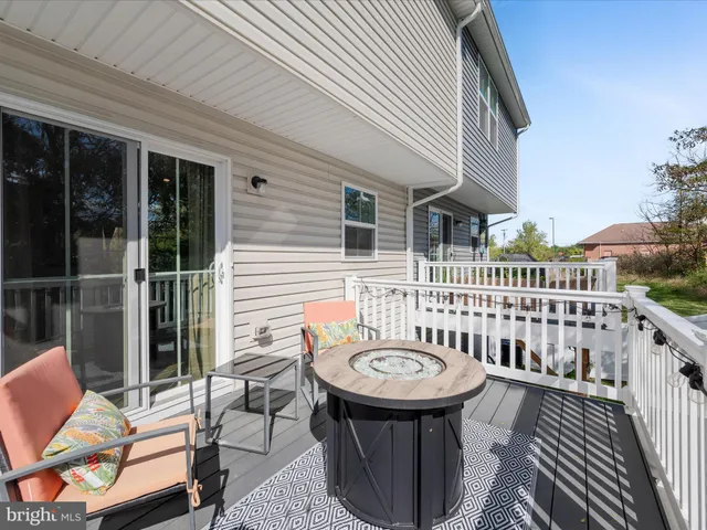 a view of a chair and table in the balcony