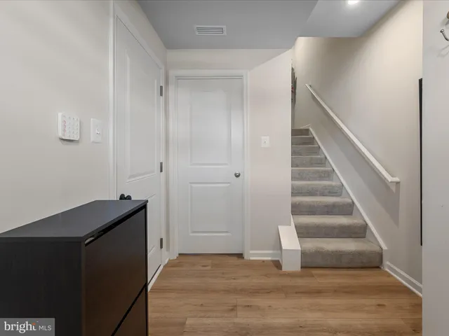 a view of entryway and hall with wooden floor