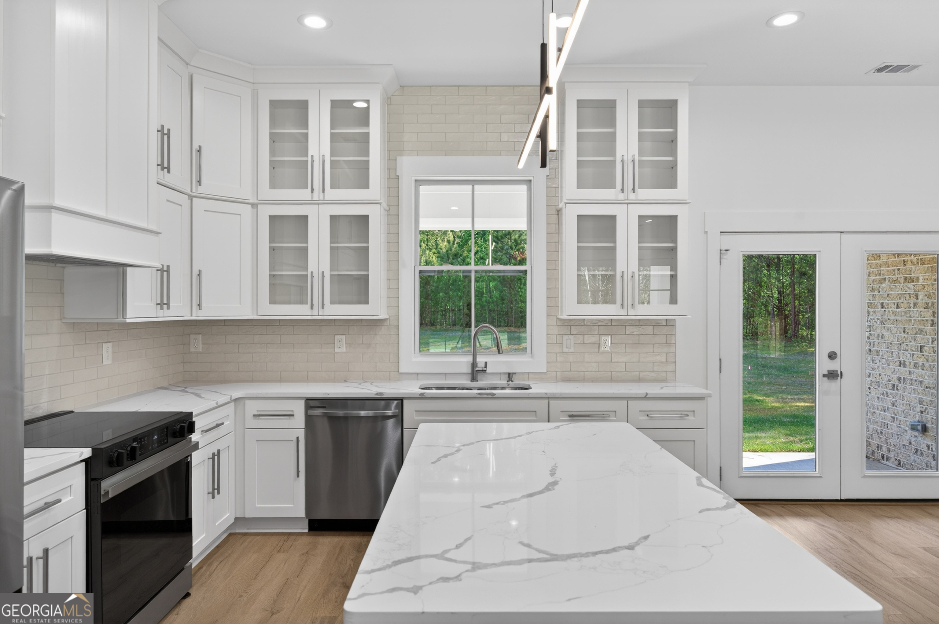 1455 Laney Drive Locust Grove, GA 30248 - Photo 12 of 37 a kitchen with a stove a sink and a cabinets