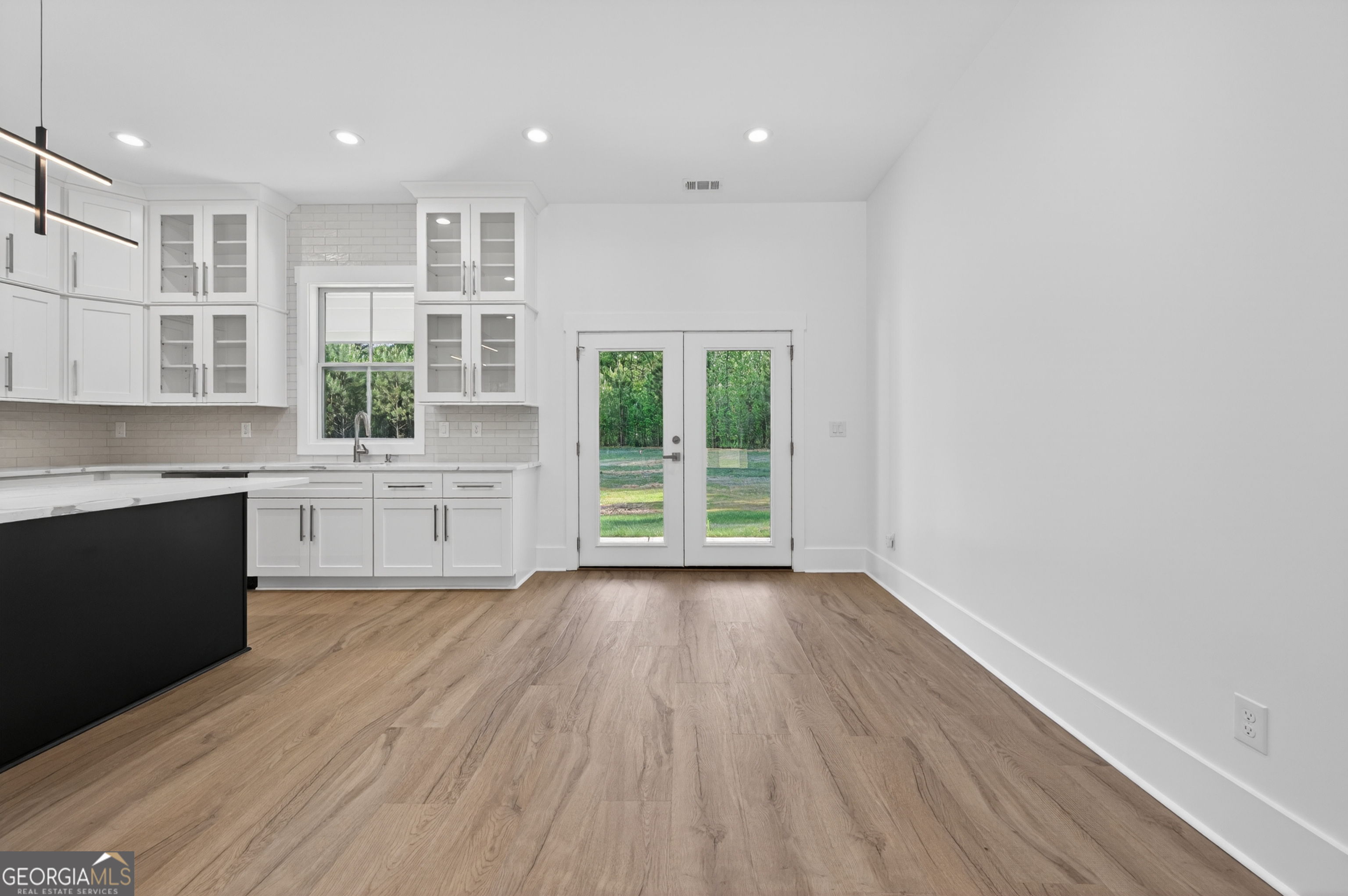 1455 Laney Drive Locust Grove, GA 30248 - Photo 13 of 37 a large kitchen with cabinets wooden floor and a window