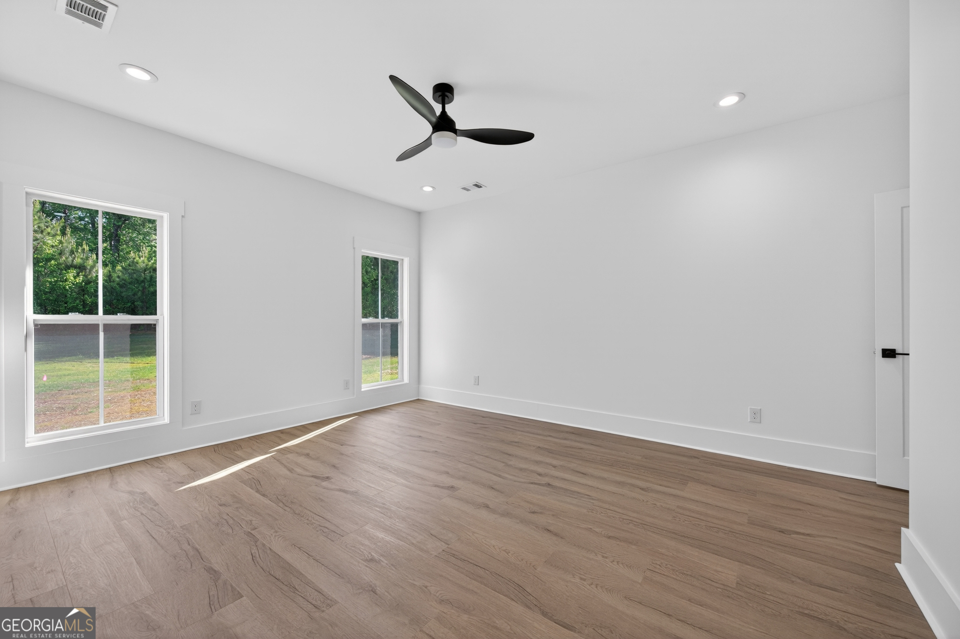 1455 Laney Drive Locust Grove, GA 30248 - Photo 16 of 37 a view of an empty room with wooden floor and a window