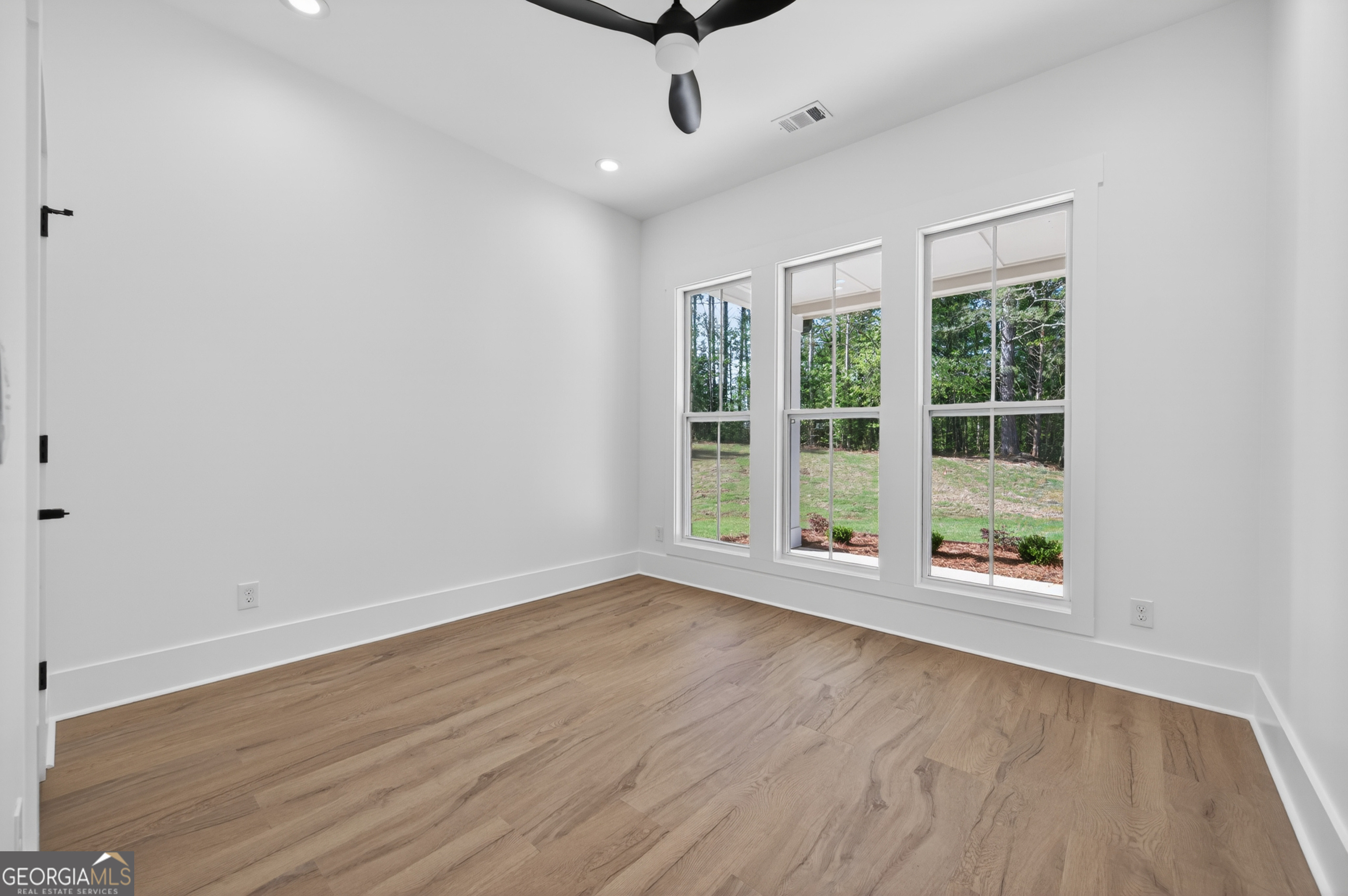 1455 Laney Drive Locust Grove, GA 30248 - Photo 23 of 37 wooden floor in an empty room with a window