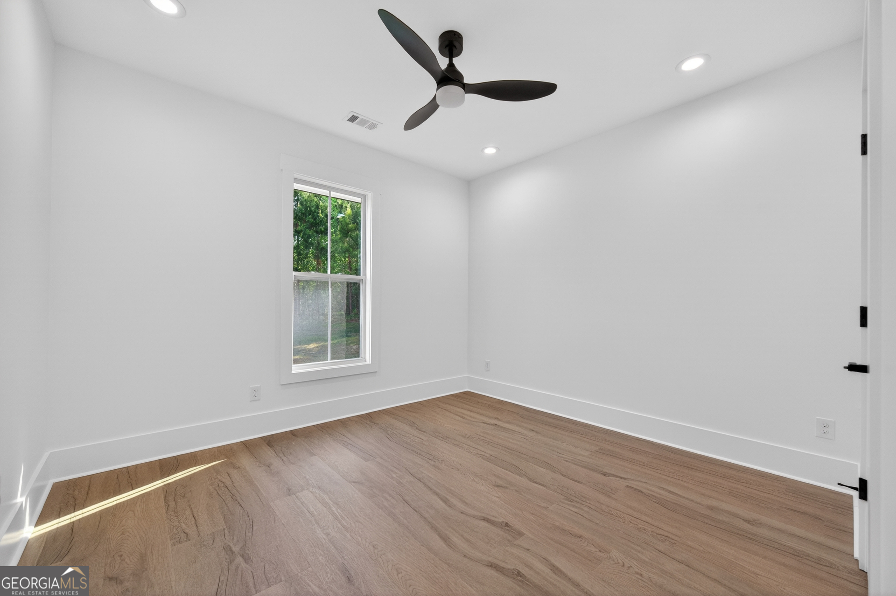 1455 Laney Drive Locust Grove, GA 30248 - Photo 24 of 37 wooden floor in an empty room with a window