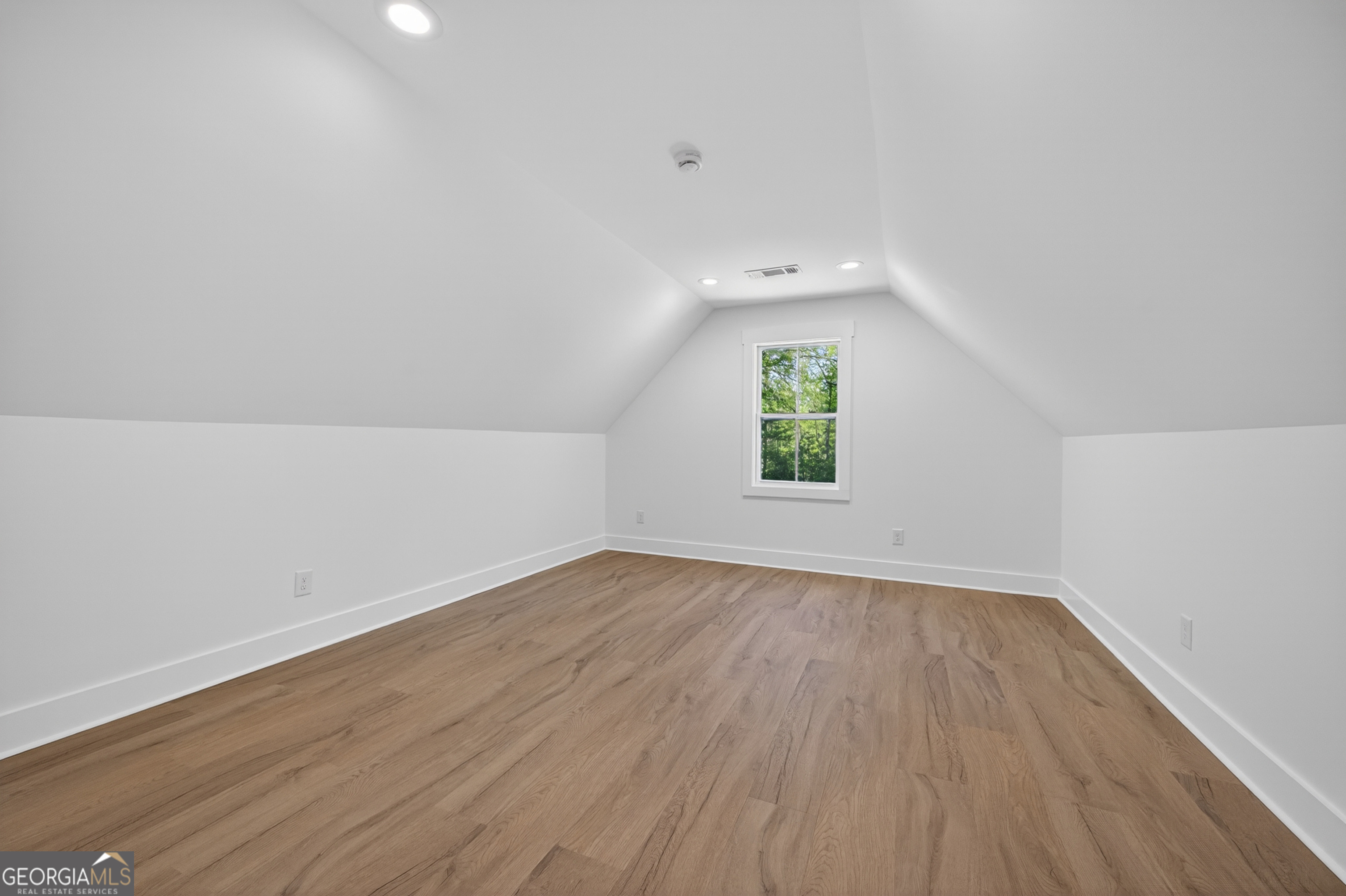 1455 Laney Drive Locust Grove, GA 30248 - Photo 27 of 37 an empty room with wooden floor and windows
