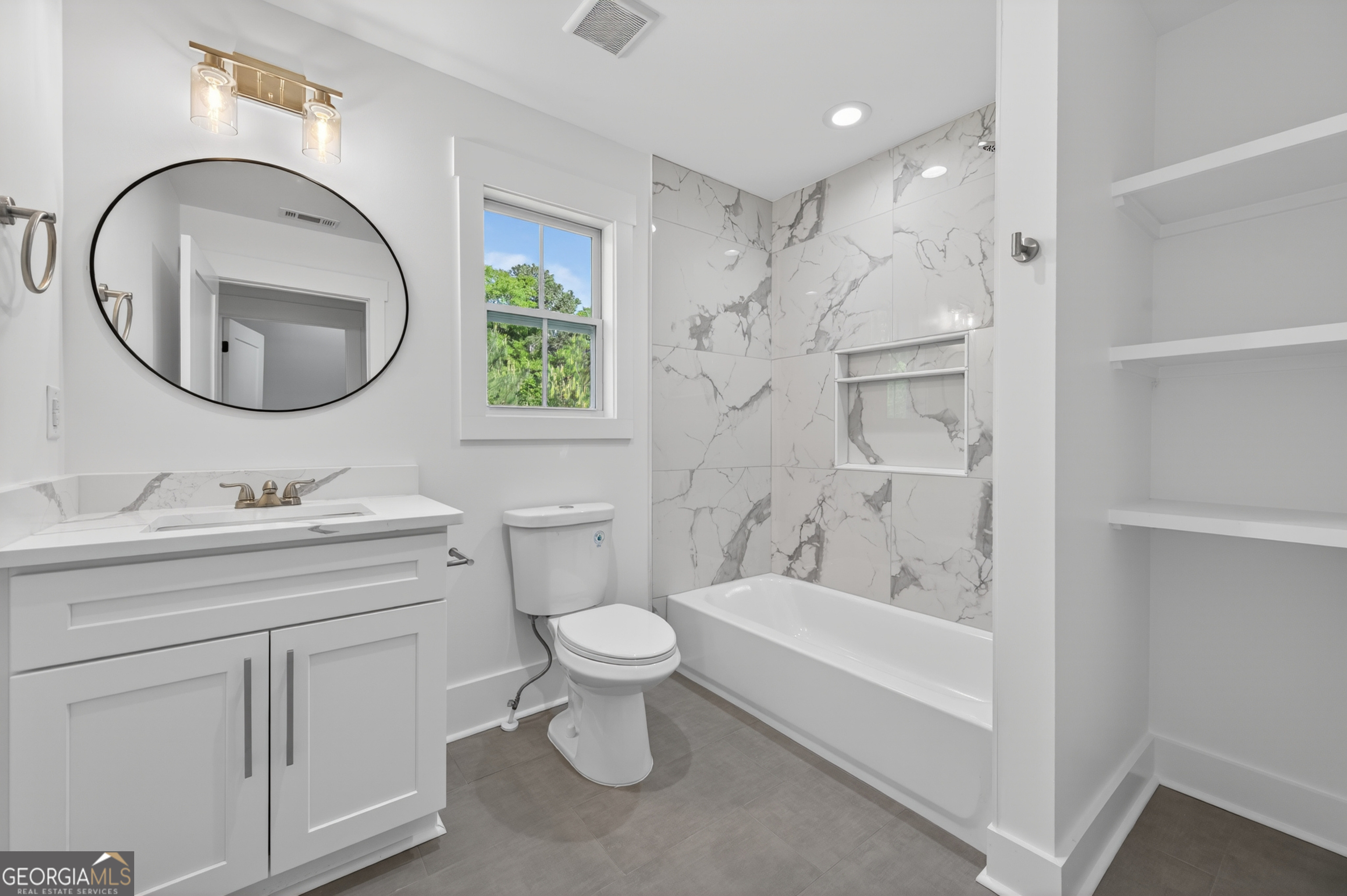 1455 Laney Drive Locust Grove, GA 30248 - Photo 28 of 37 a bathroom with a toilet sink and mirror