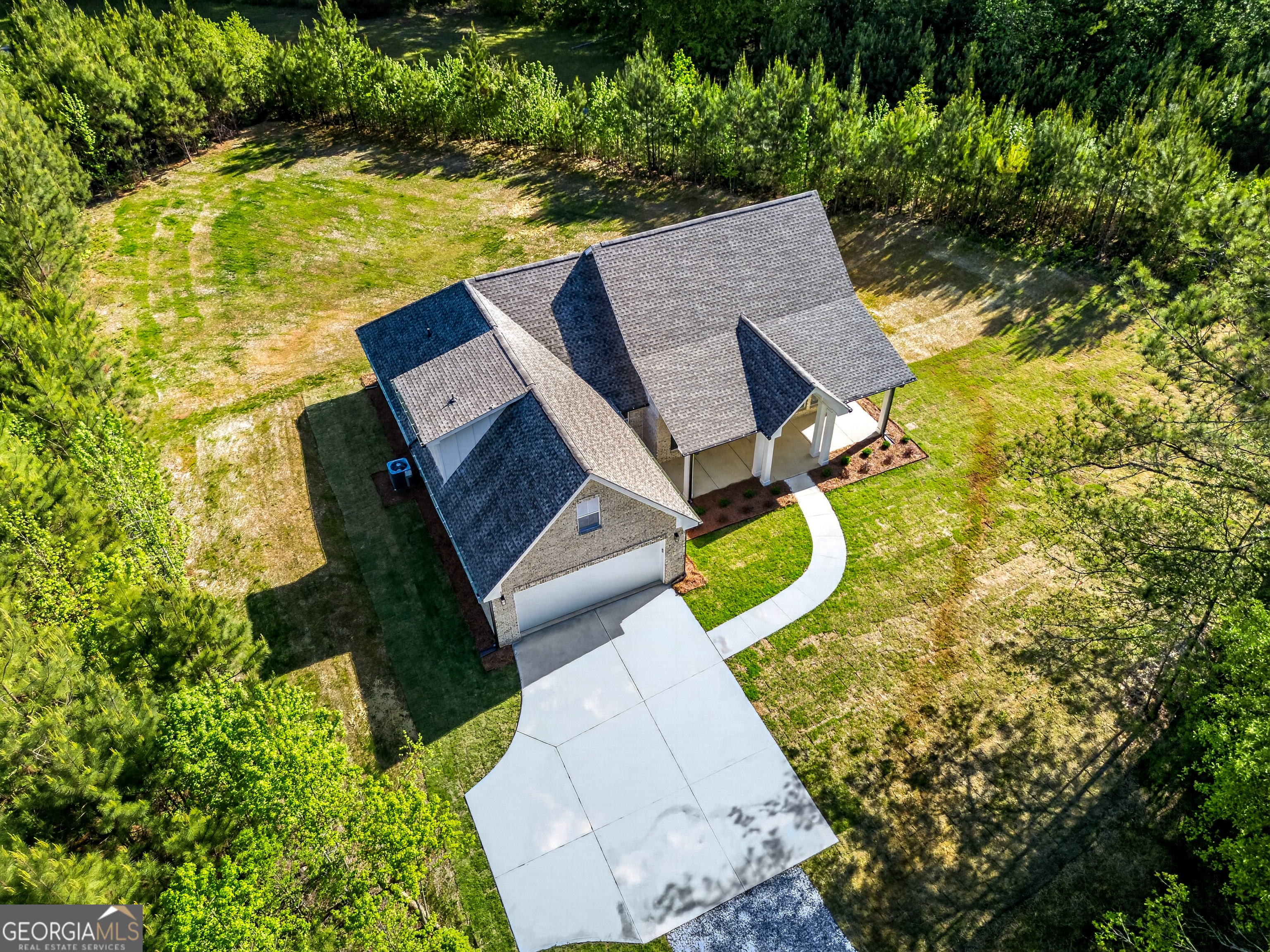 1455 Laney Drive Locust Grove, GA 30248 - Photo 33 of 37 an aerial view of a house with swimming pool and large trees