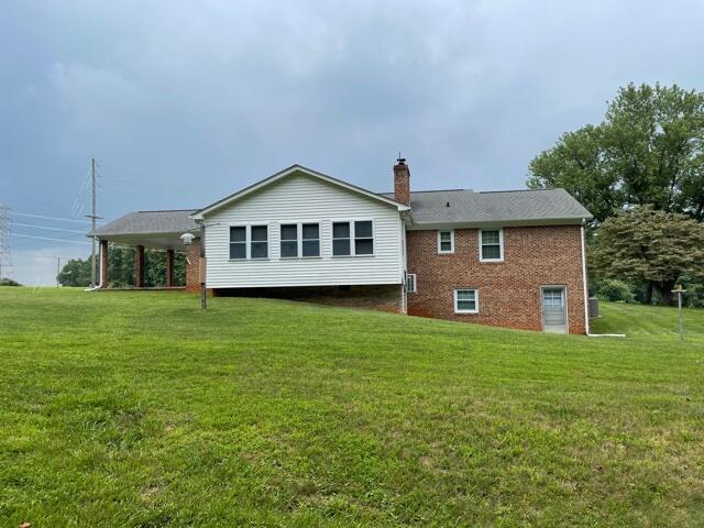 78 Robertson Ridge Road Axton, VA 24054 - Photo 18 of 22 a front view of a house with a garden