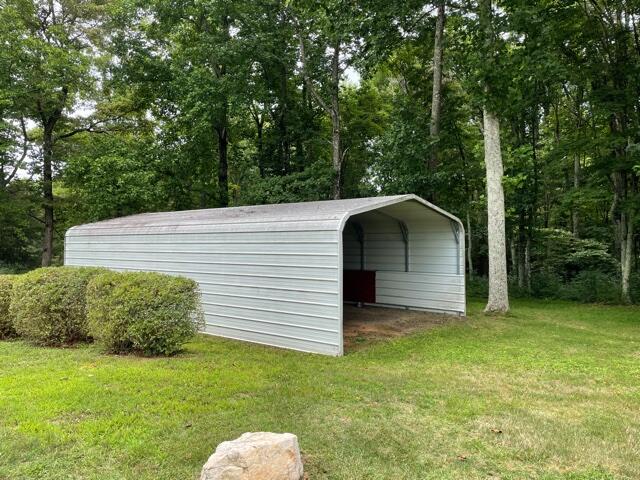 78 Robertson Ridge Road Axton, VA 24054 - Photo 20 of 22 a backyard of a house with large trees and entertaining space