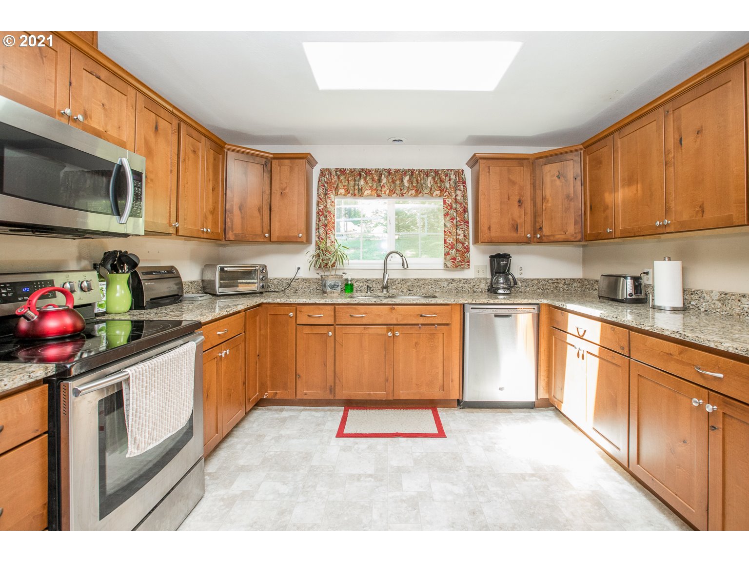 90361 Baker Road Elmira, OR 97437 - Photo 12 of 26 a kitchen with stainless steel appliances granite countertop a stove a sink dishwasher and a microwave oven with cabinets