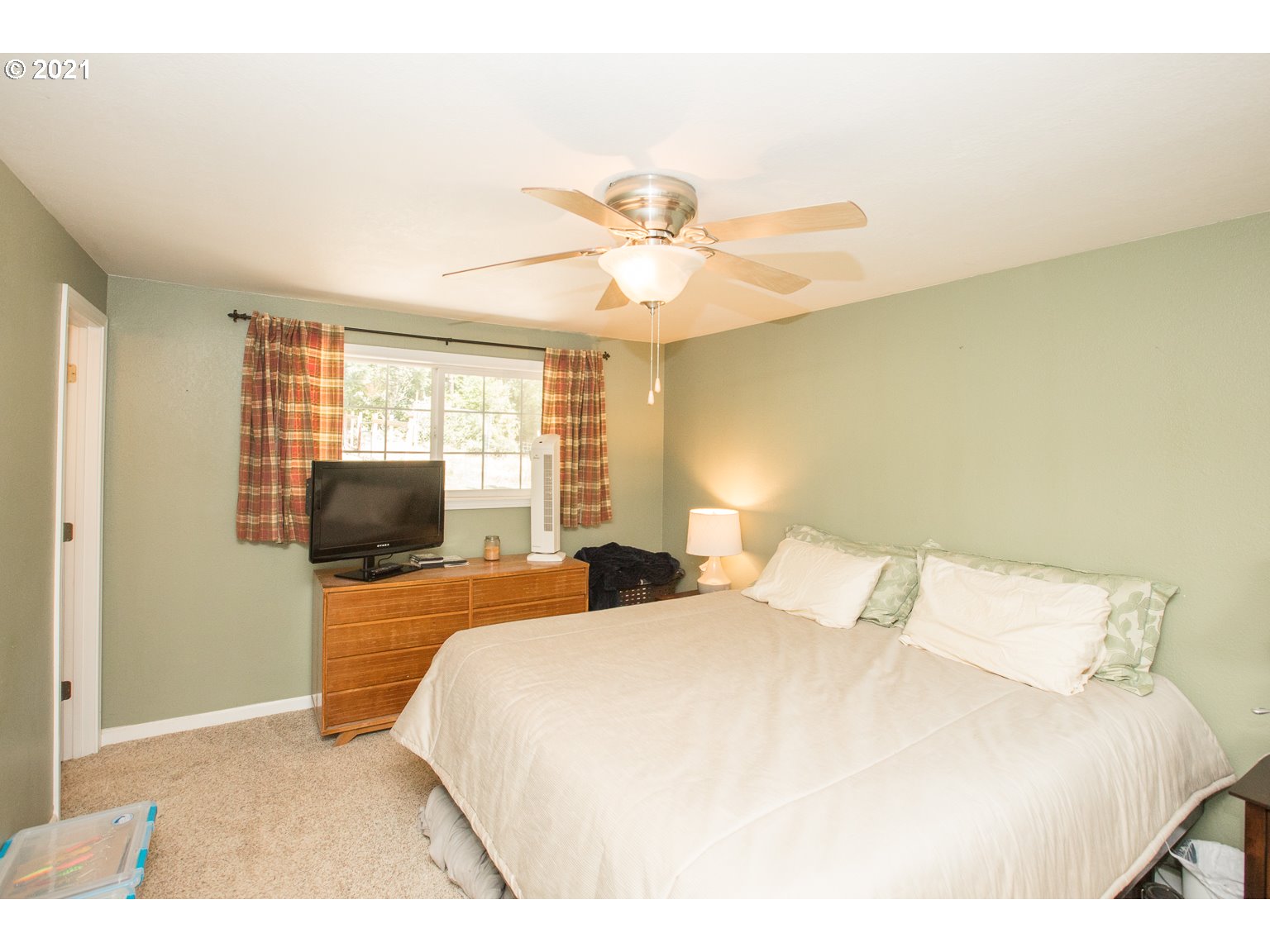90361 Baker Road Elmira, OR 97437 - Photo 14 of 26 a bedroom with a bed and a chandelier