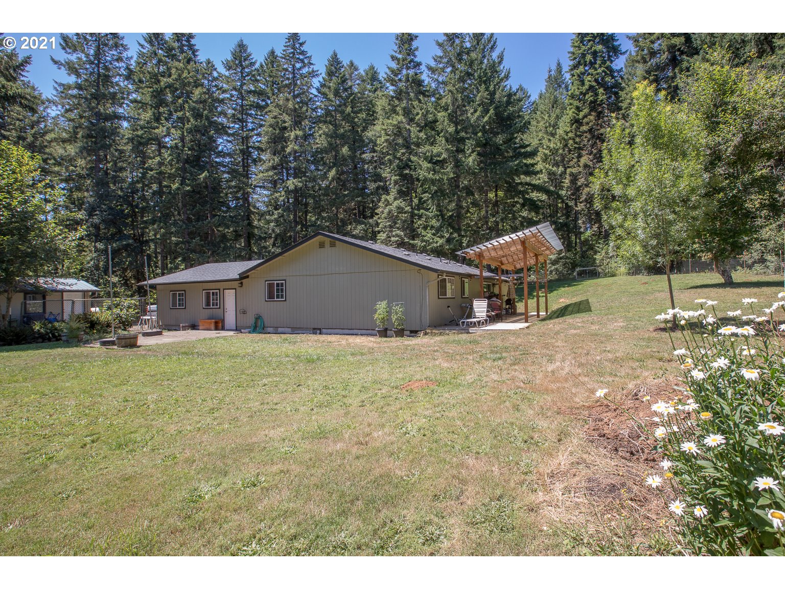 90361 Baker Road Elmira, OR 97437 - Photo 19 of 26 a backyard of a house with table and chairs