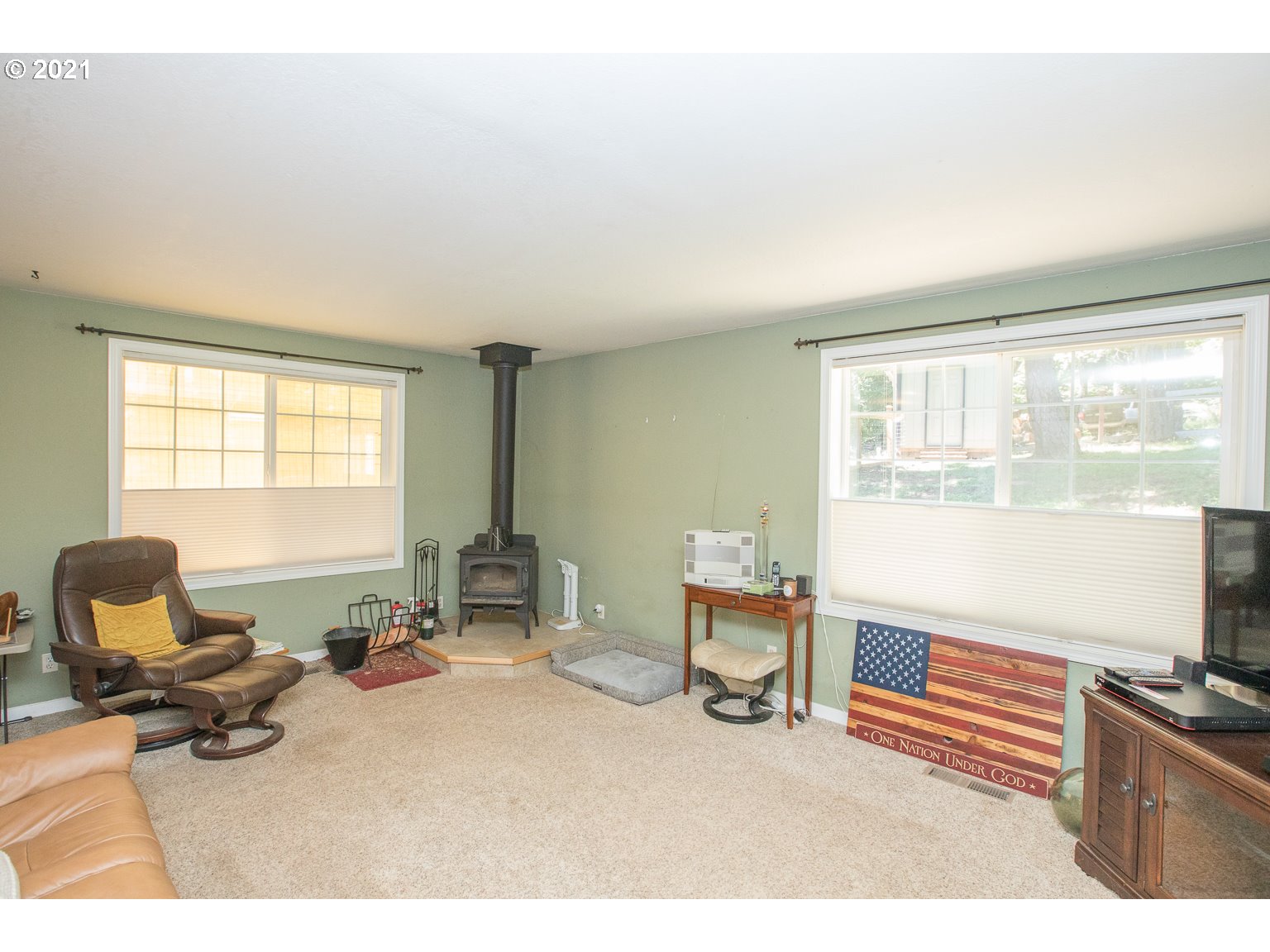 90361 Baker Road Elmira, OR 97437 - Photo 3 of 26 a living room with furniture a flat screen tv and large windows